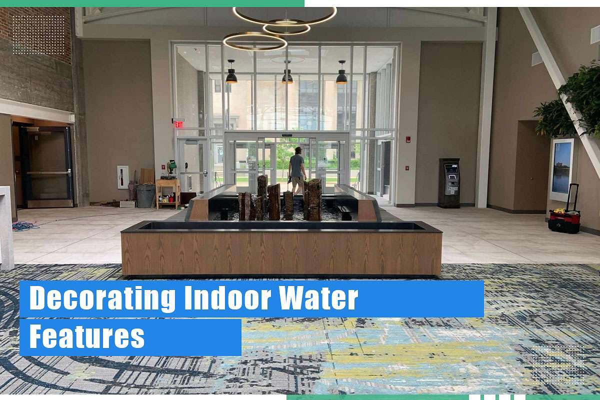 Indoor water feature installation in a modern lobby, featuring a decorative water wall with stone accents and a contemporary design, enhancing the aesthetic appeal of commercial spaces.