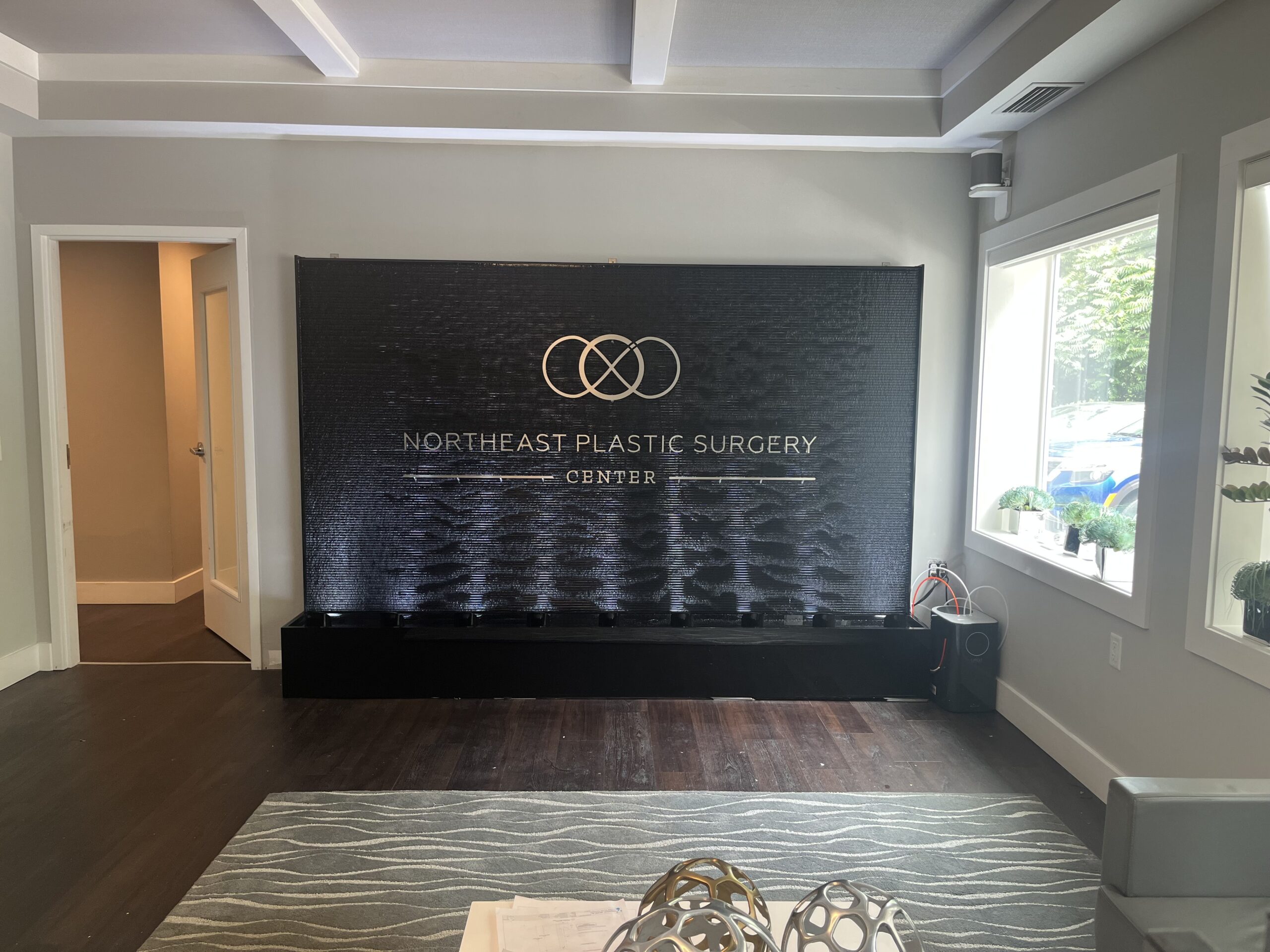 Acrylic Water Features 36 Black Scored Acrylic Water Wall with Logo for NORTHEAST PLASTIC SURGERY CENTER in Old Lyme Connecticut 2 scaled