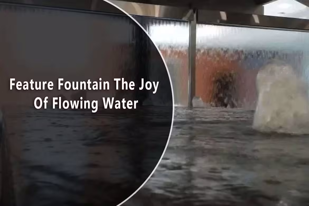 Feature fountain showcasing the joy of flowing water, highlighting a serene indoor water installation with a reflective surface and cascading water effects.