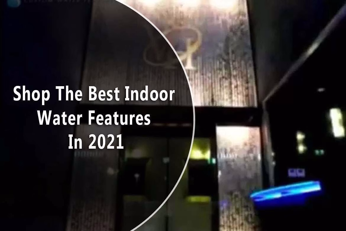 Indoor water feature display with glass wall waterfall, illuminated design, and promotional text for shopping the best indoor water features in 2021.