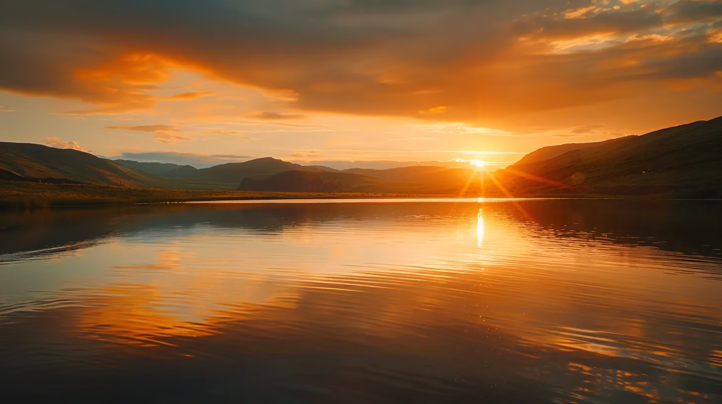 Choosing Materials for Your Perfect Water Fall Wall 4 a breathtaking sunset casts a warm golden glow over a serene mountain landscape, with vibrant hues reflecting in a tranquil lake below.