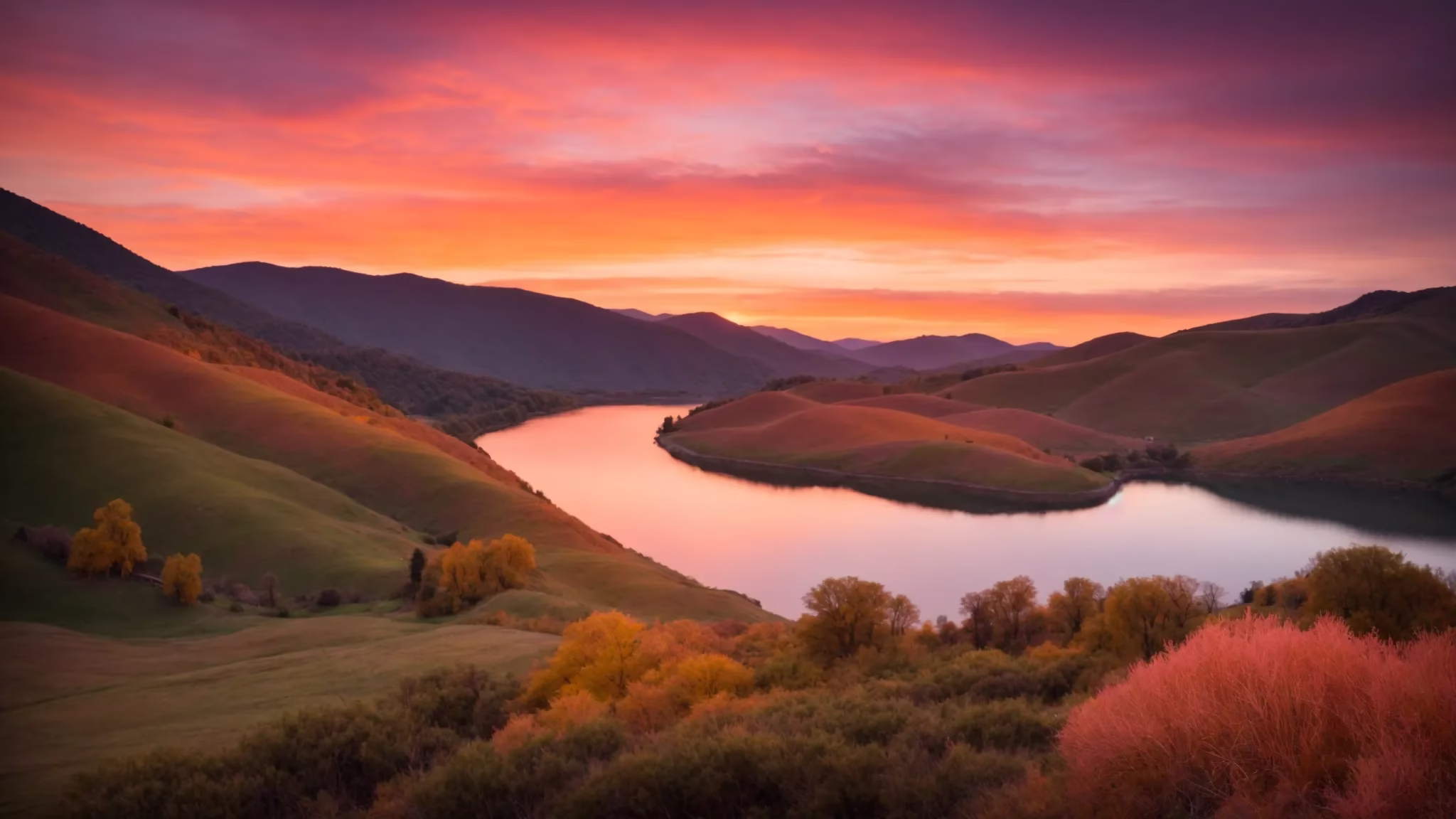 Advantages of Using a Mesh Wall for Outdoor Areas 4 a breathtaking sunrise paints the sky in vibrant hues of orange and pink, casting a warm glow over a serene landscape of rolling hills and a tranquil lake reflecting the dazzling colors.