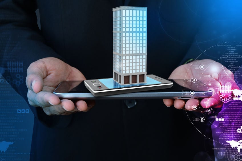 smart hand showing smart phone with real estate concept