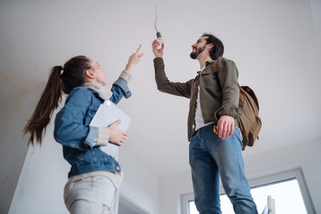 Low angle view of young couple moving and planning in new flat, new home and relocation concept
