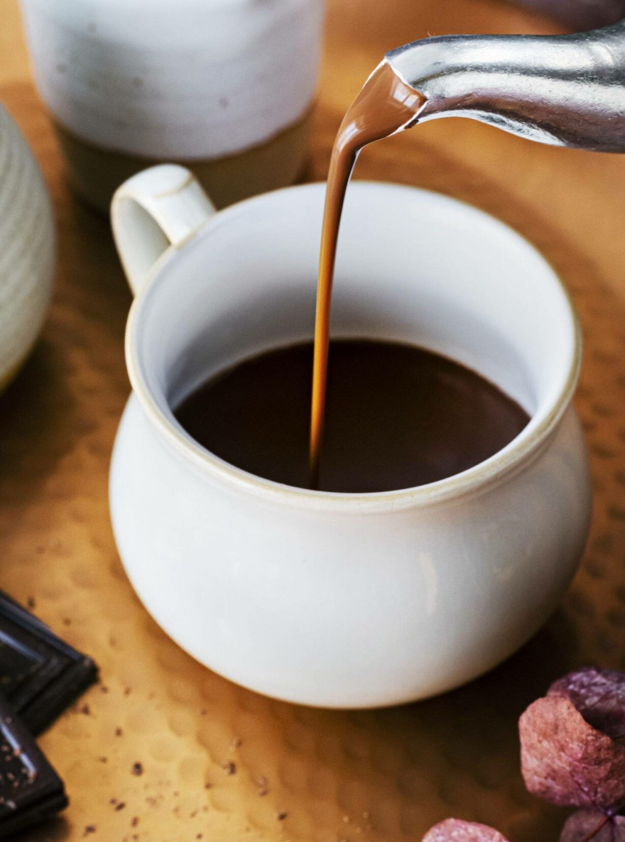 Pouring hot chocolate from a kettle food photography Pouring hot chocolate from a kettle food photography