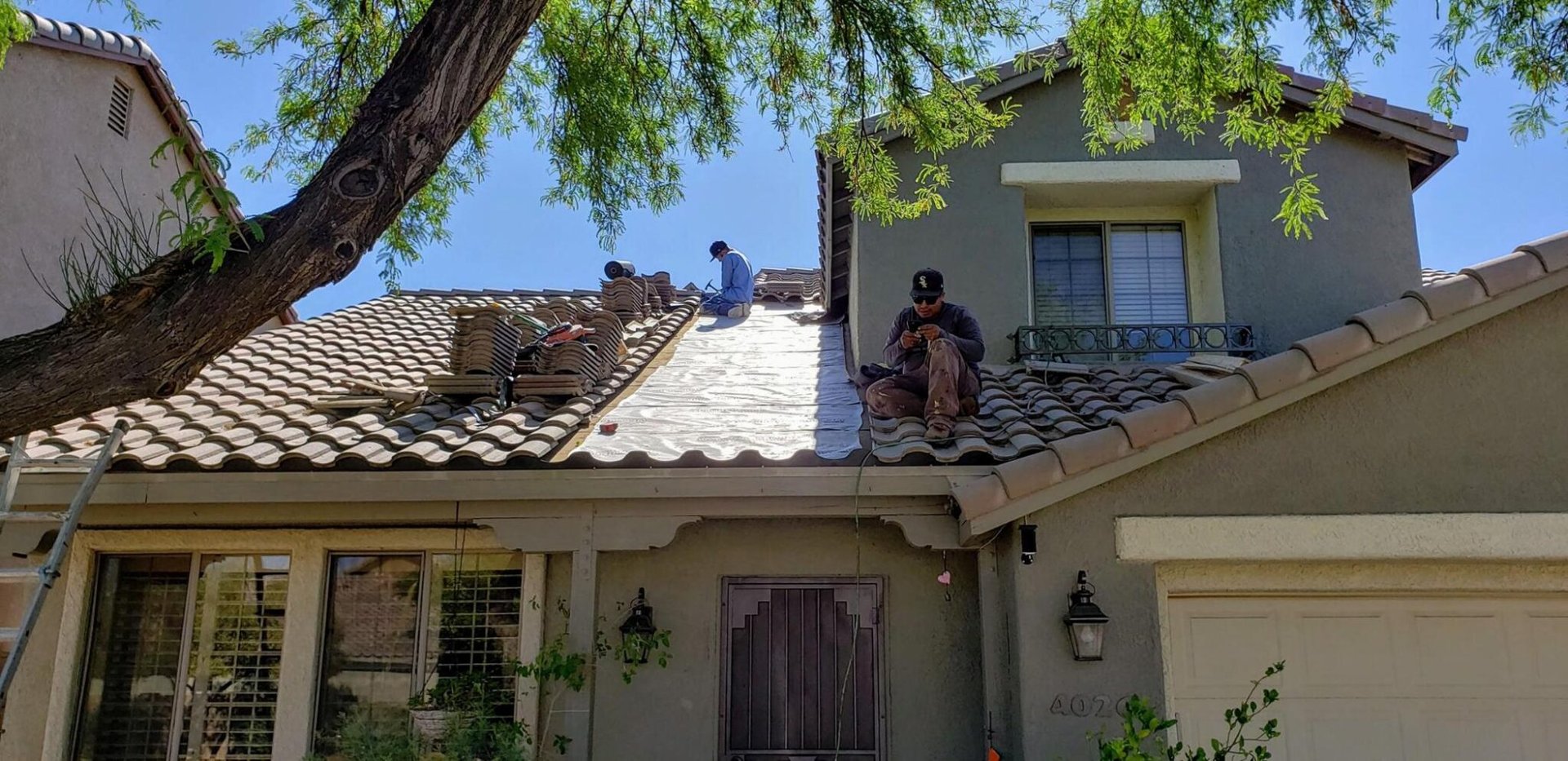 DC on roof DC Roofing - Repairing a tile roof in Tucson, AZ