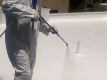 commercial roof coatings DC Roofing spraying on commercial roof coating in Tucson