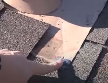 metal-flashing-under-roof-penetration-boot well sealed nail holding metal flashing to rooftop