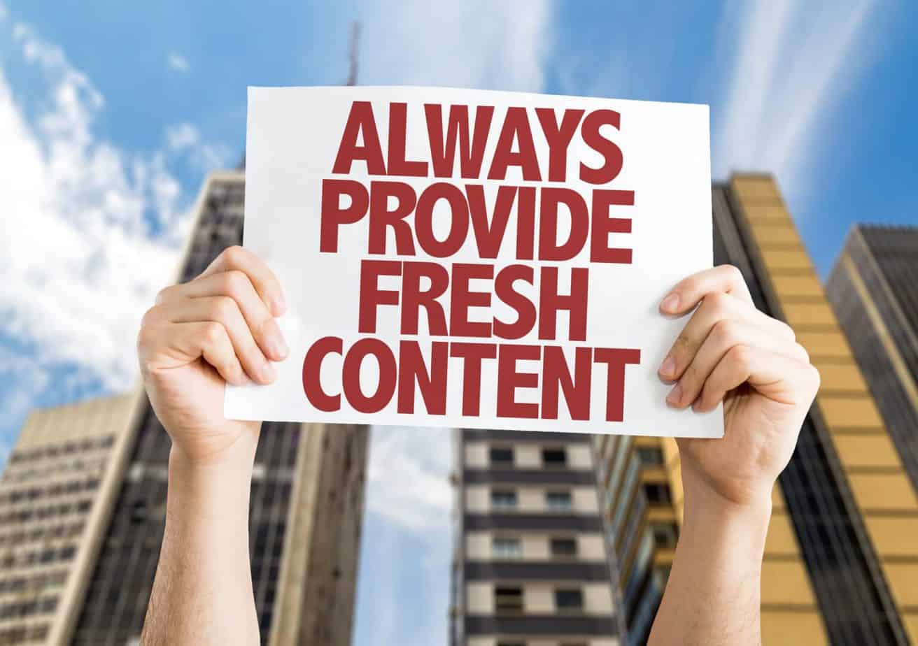Person holding a sign that says always provide fresh content