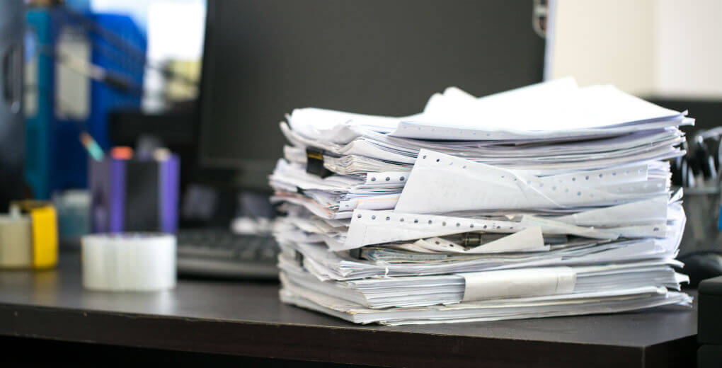 Stack of paperwork on work desk A big stack of paperwork on a work desk