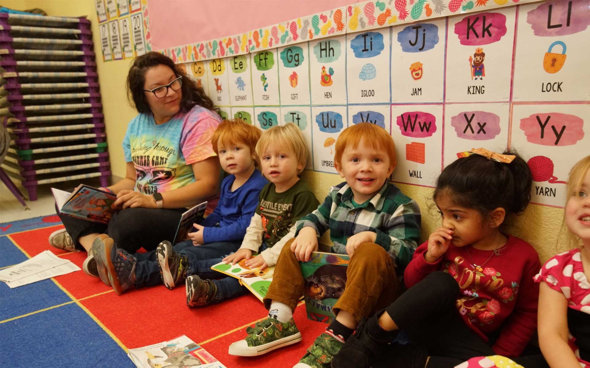 children lined up against the wall at luv n care