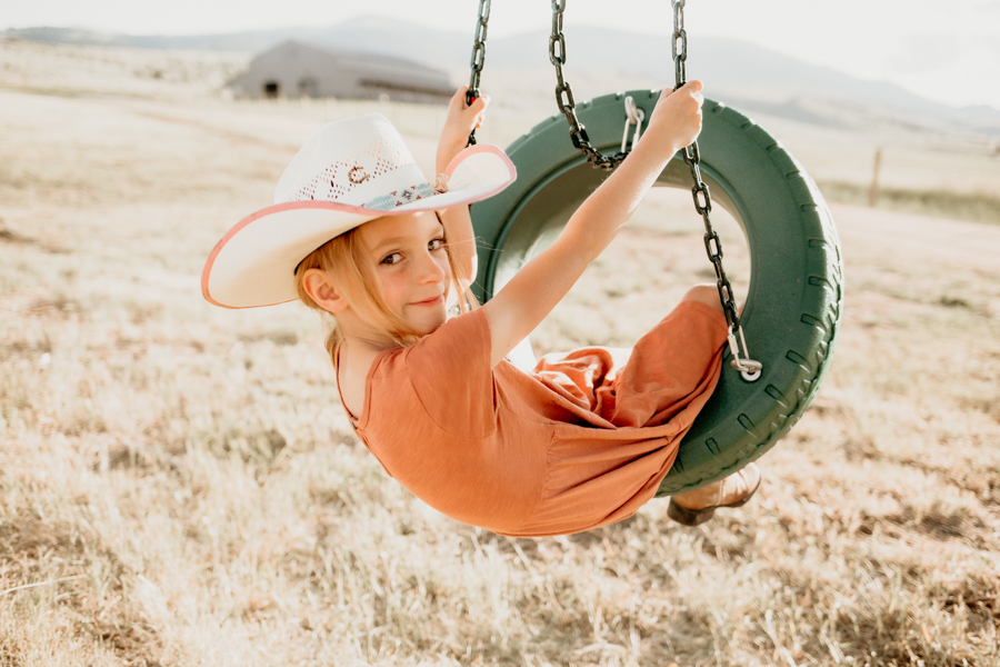 6G4A3266 Little cowgirl on a tire swing portrait