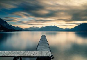 brown wooden dock on lake during daytime