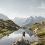 person standing on rock mountain during daytime