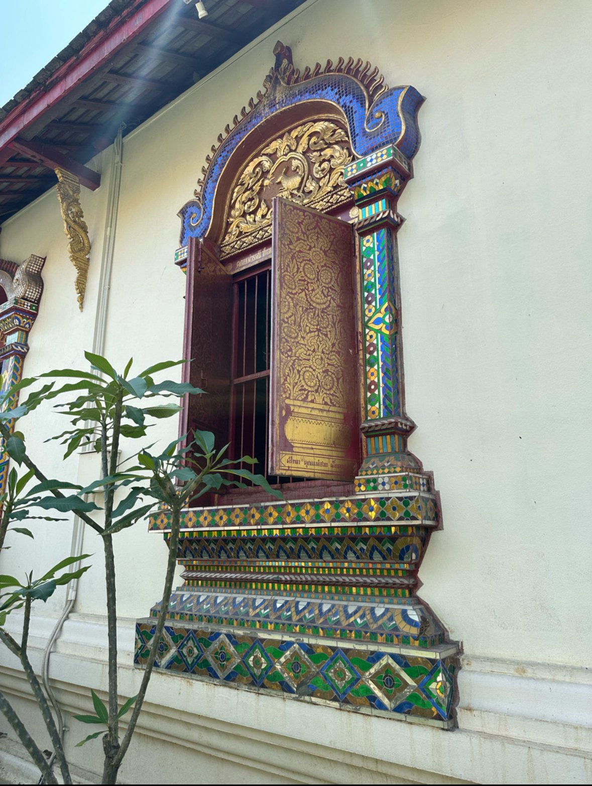 Decorated window at the side of a temple in the Grand Palace, Bangkok