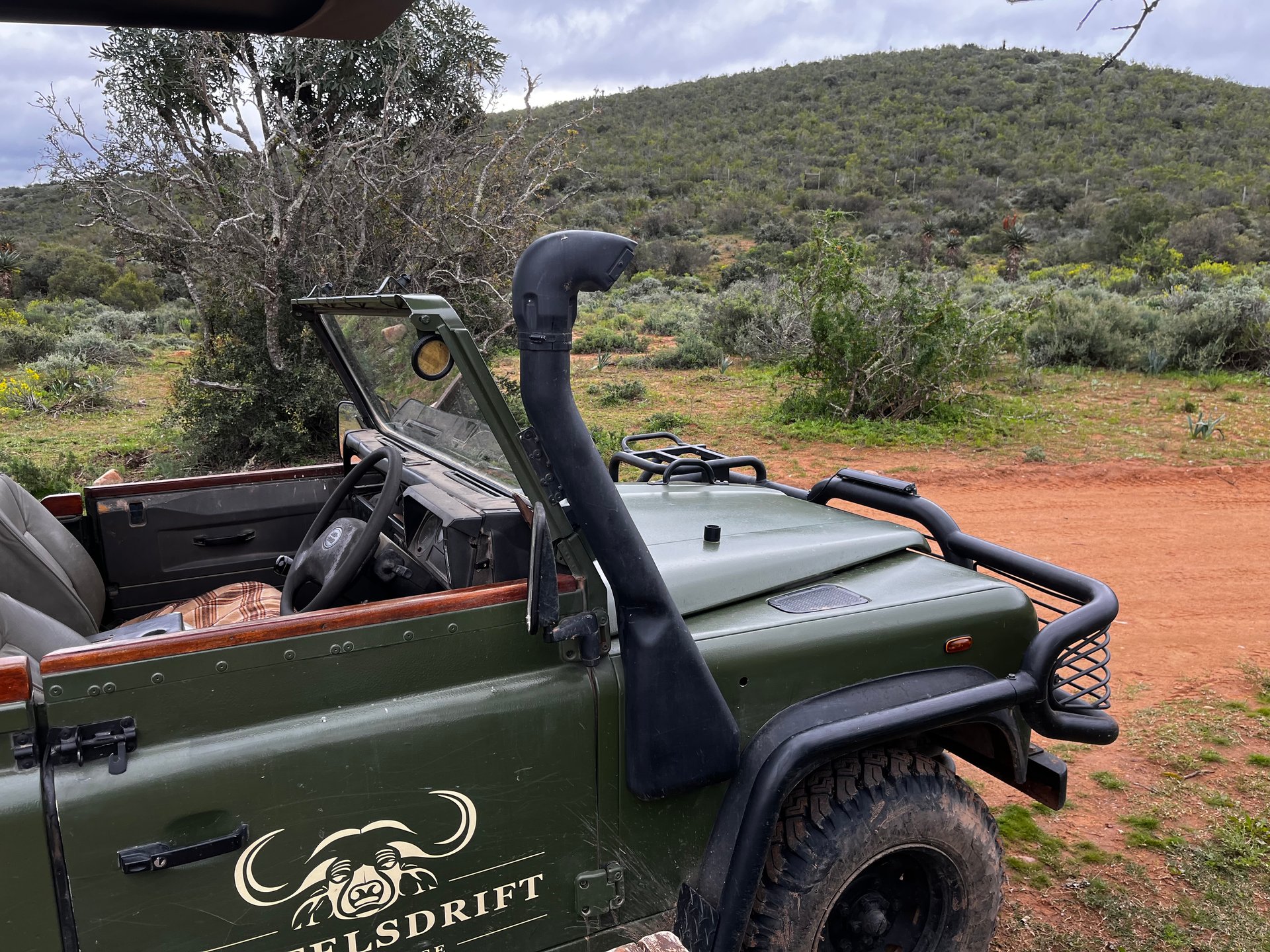 Open safari truck on a dirt road in South Africa