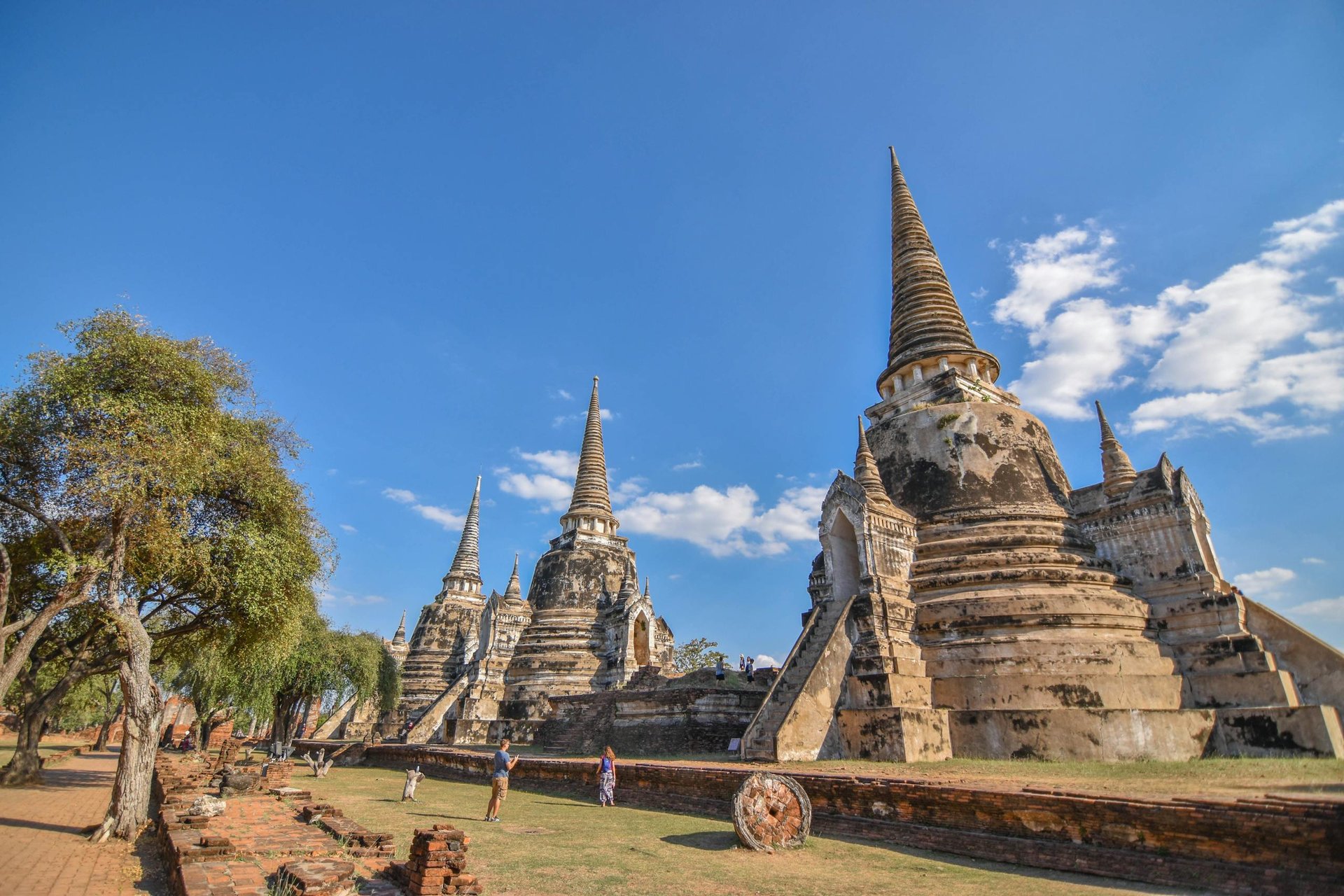 Explore the ancient pagodas of Ayutthaya Historical Park on a clear sunny day in Thailand.