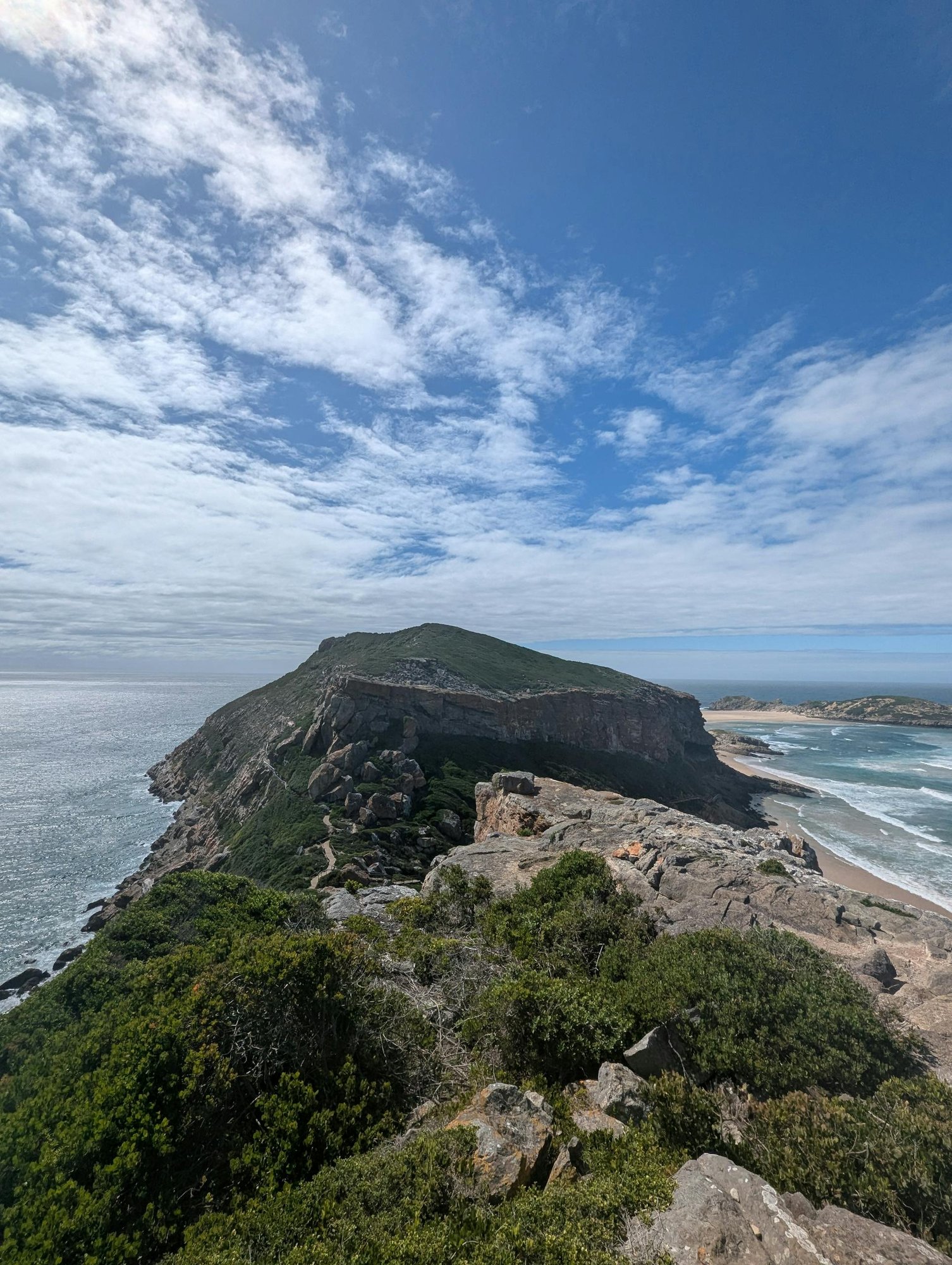 Breathtaking view of Robberg Peninsula in South Africa, showcasing rocky cliffs and ocean.