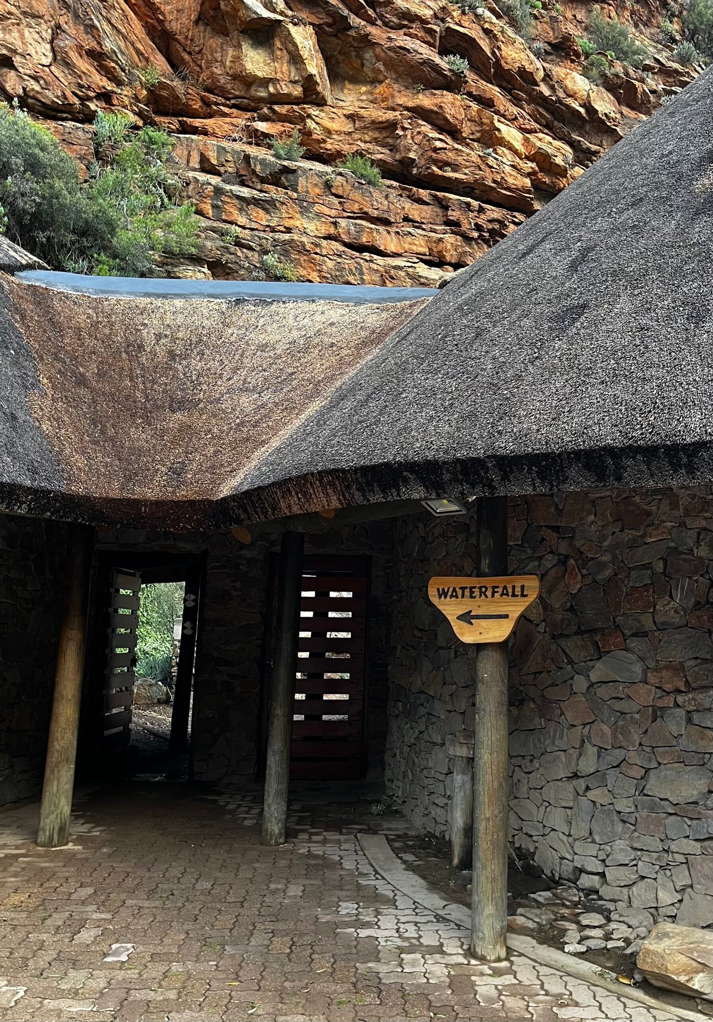 Sign leading to the waterfall at Meiringspoort Pass, with thatch-roofed buildings. Seen on the way back from driving the Swartberg Pass.