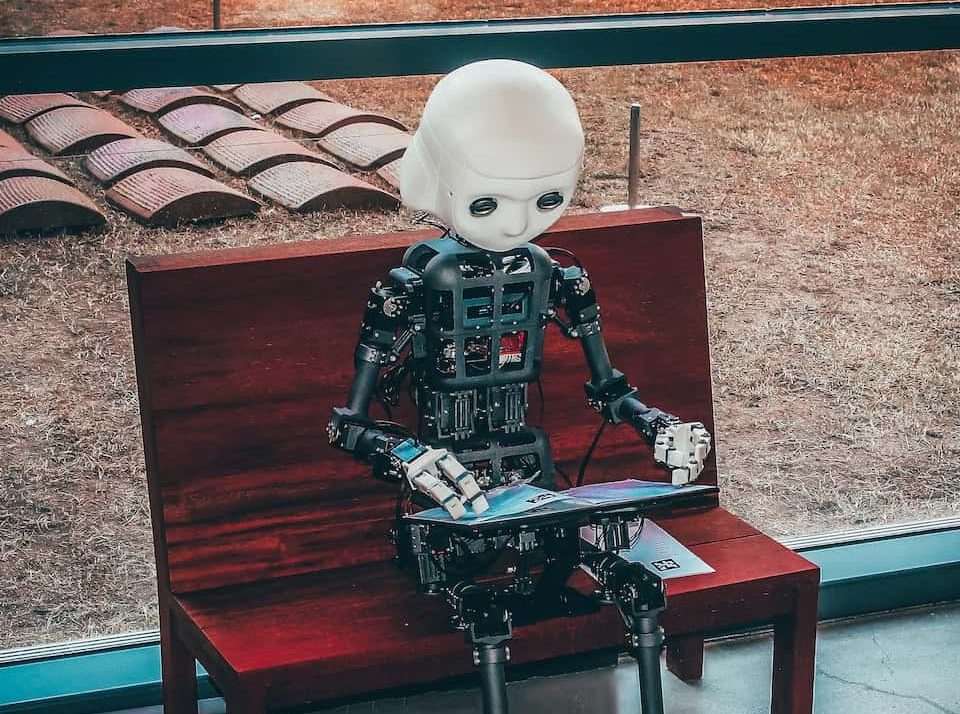 black and white robot toy on red wooden table