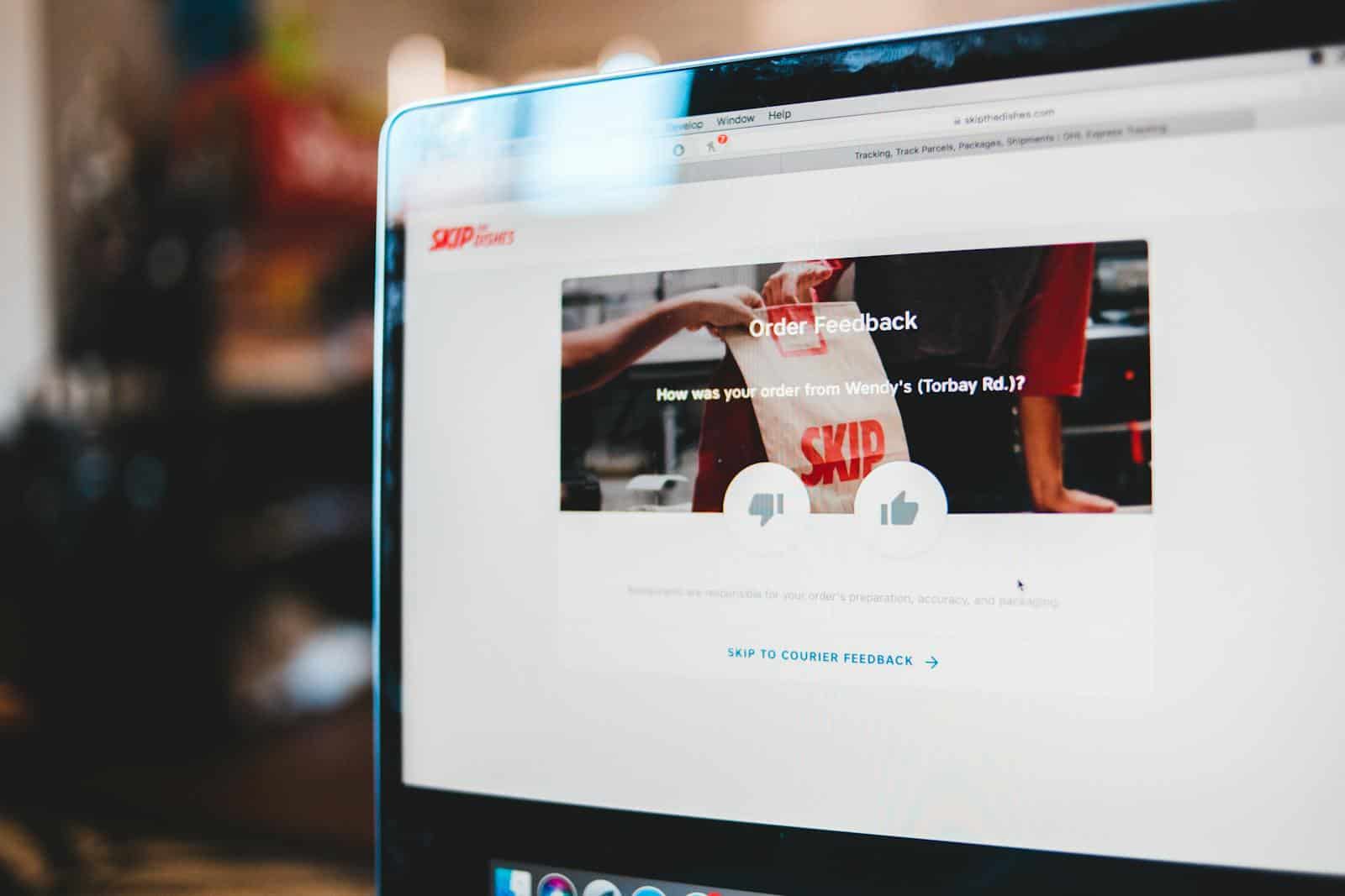 Online survey, Online feedback form interface on laptop screen illustrating user interaction with delivery service.