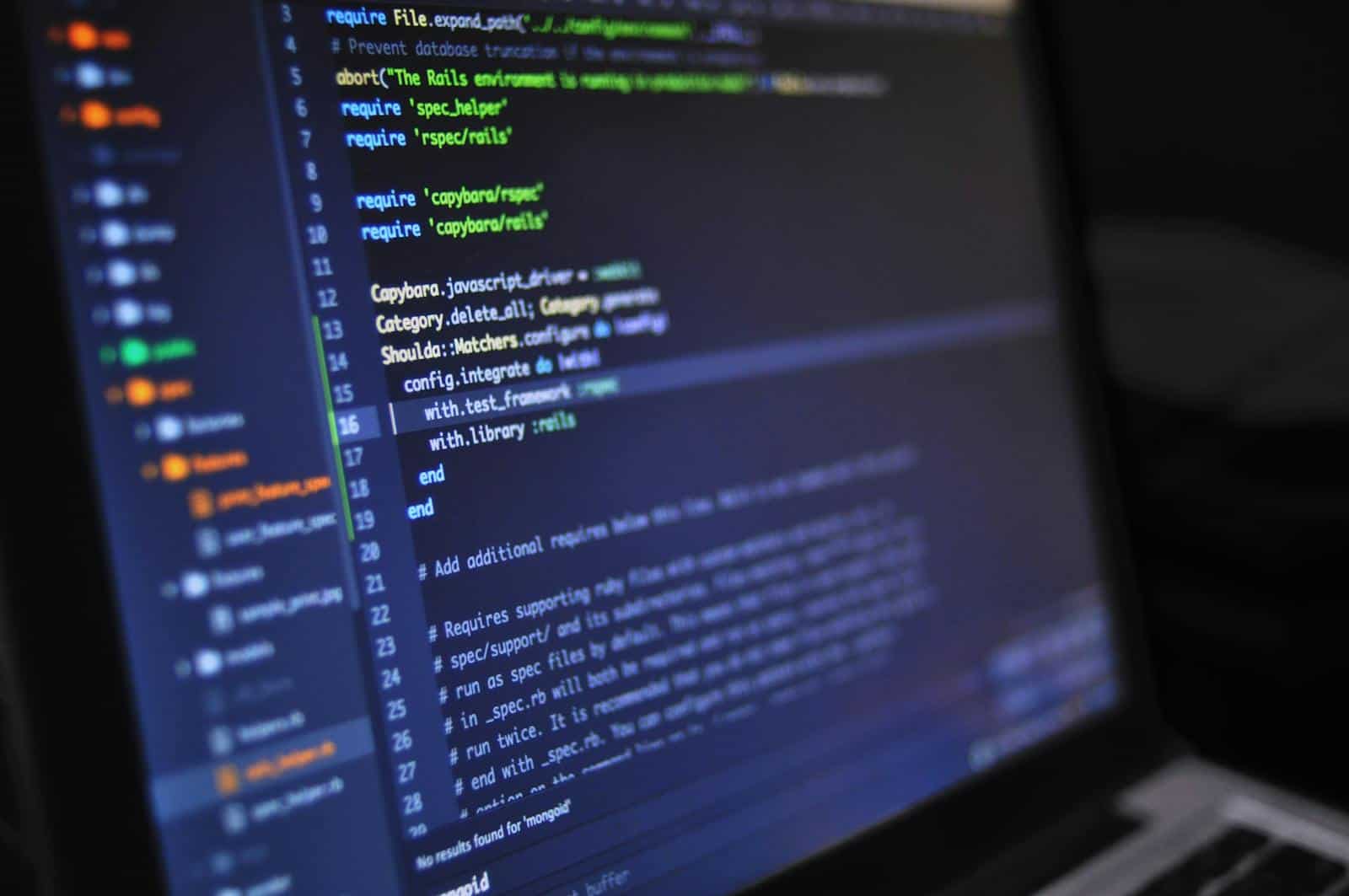 Algorithm, Close-up of a computer screen displaying programming code in a dark environment.