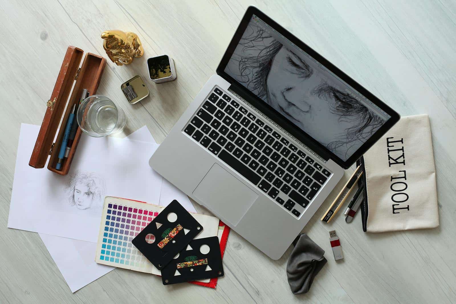 digital illustration, Top view of a creative workspace with a laptop, sketch supplies, and color palette.