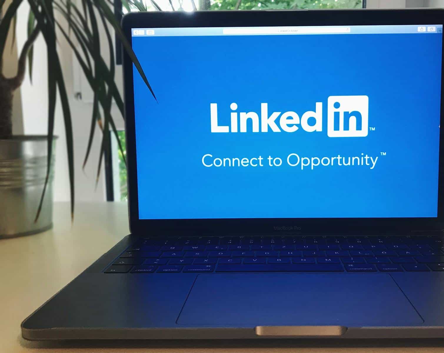LinkedIn Marketing, A laptop screen displaying the LinkedIn logo with the text 'Connect to Opportunity'.