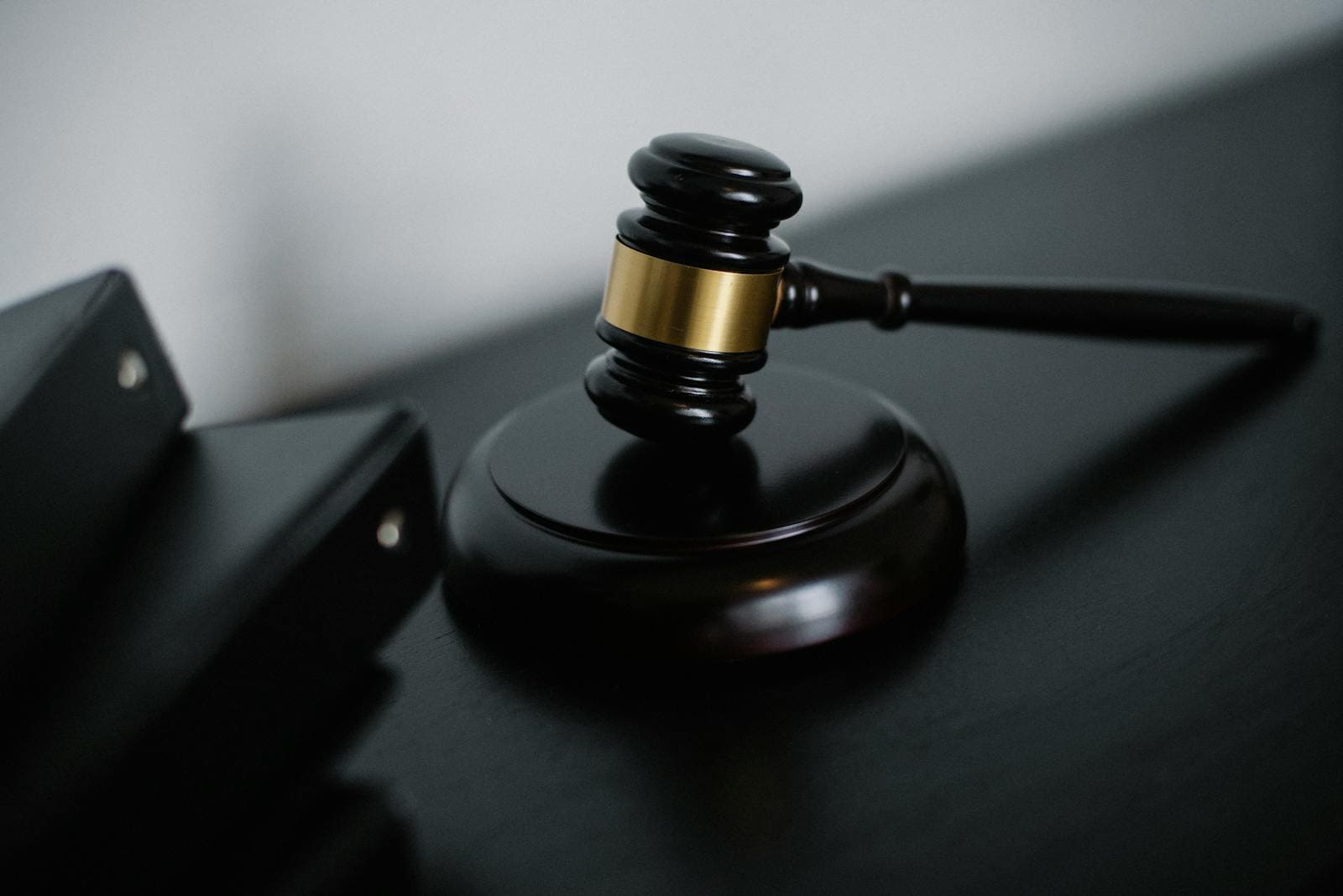 email deliverability, Close-up of a wooden gavel on a desk, symbolizing justice and legal authority.