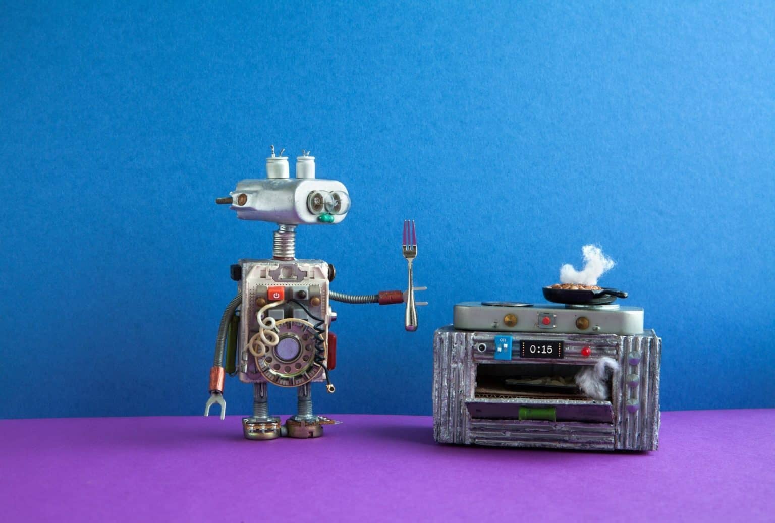 Robot chef preparing meal frying pan, electronic stove oven.