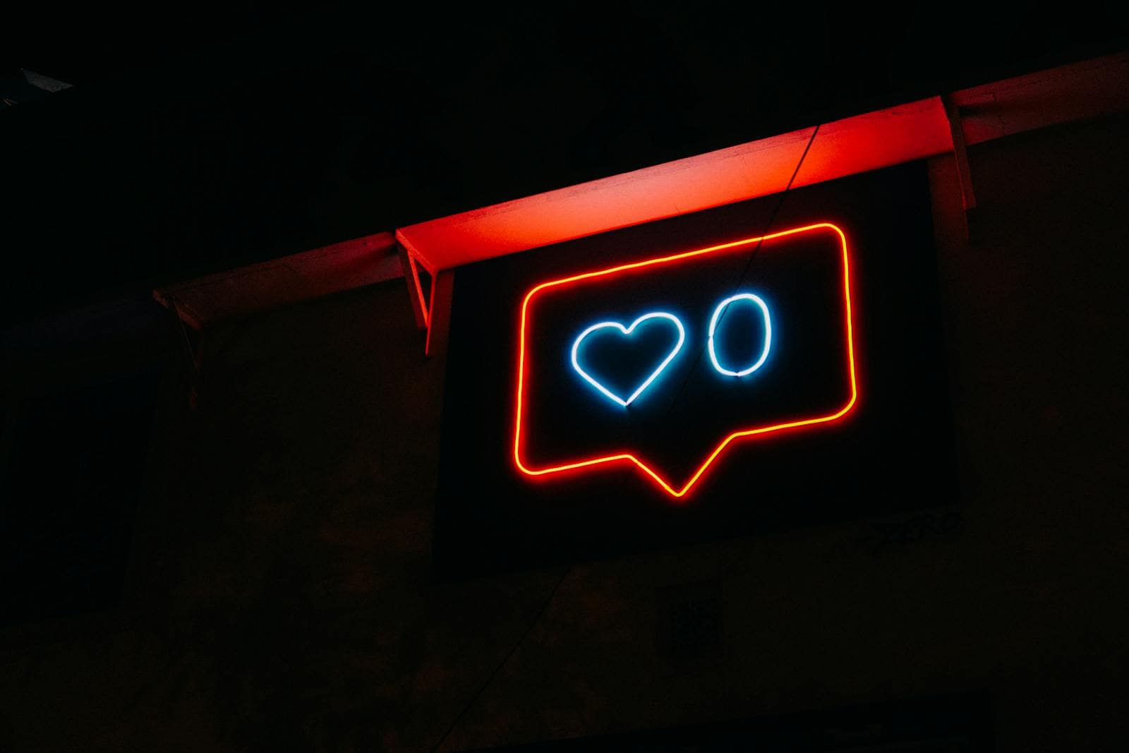 Instagram, Marketing, Algorithm, Bright neon heart icon with zero likes, symbolizing social media engagement.