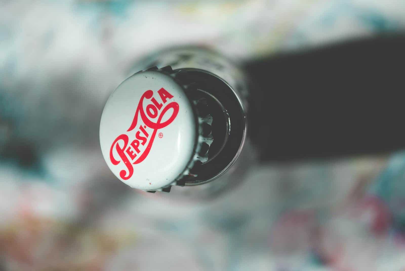 Brand Preutation, Close-up top view of an open Pepsi Cola glass bottle showcasing its iconic branding.