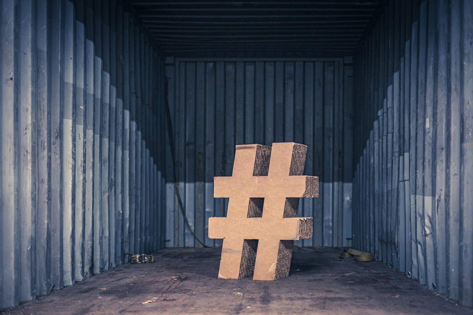 Instagram, Engagement, brown ampersand concrete statue inside an intermodal container