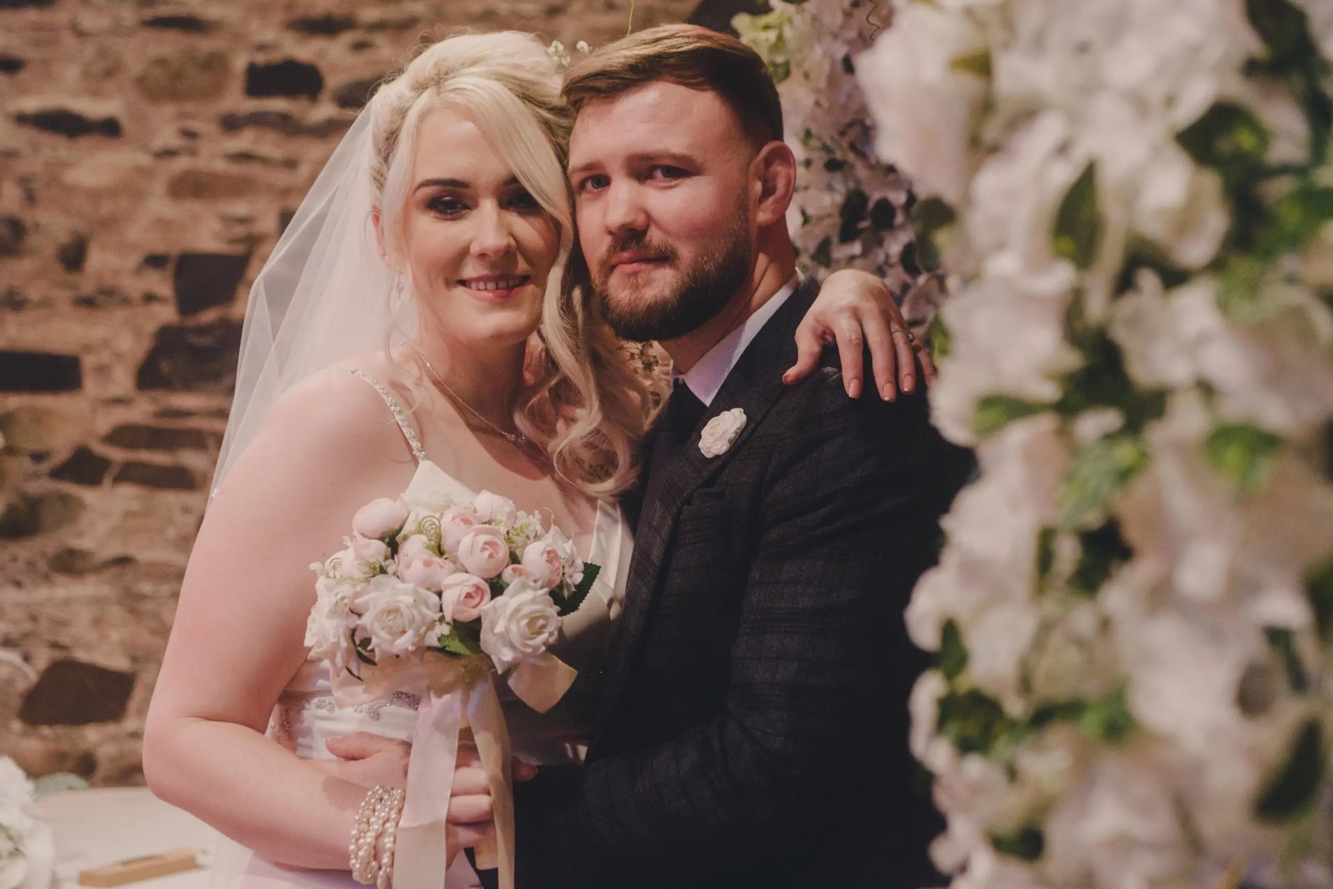 Family Photographer A bride and groom posing for a wedding photo taken by a wedding photographer.