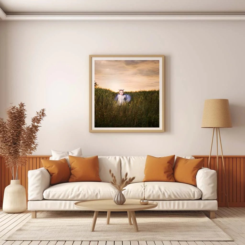 The Art of Photography: A Look into the Creative Process of a Ballymoney Photographer 1 Family Photographer A living room with a framed picture of a woman in a grassy field.
