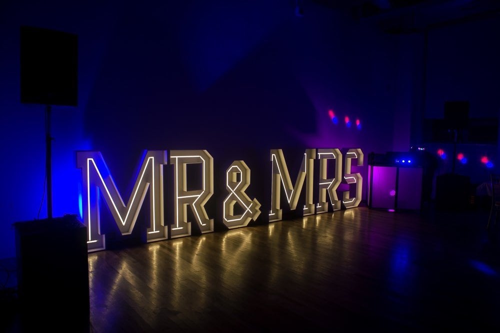 WEDDING DAY PLANNING GUIDE 1 A Northern Ireland photographer captures a lit stage with the words "Mr. and Mrs." displayed prominently.