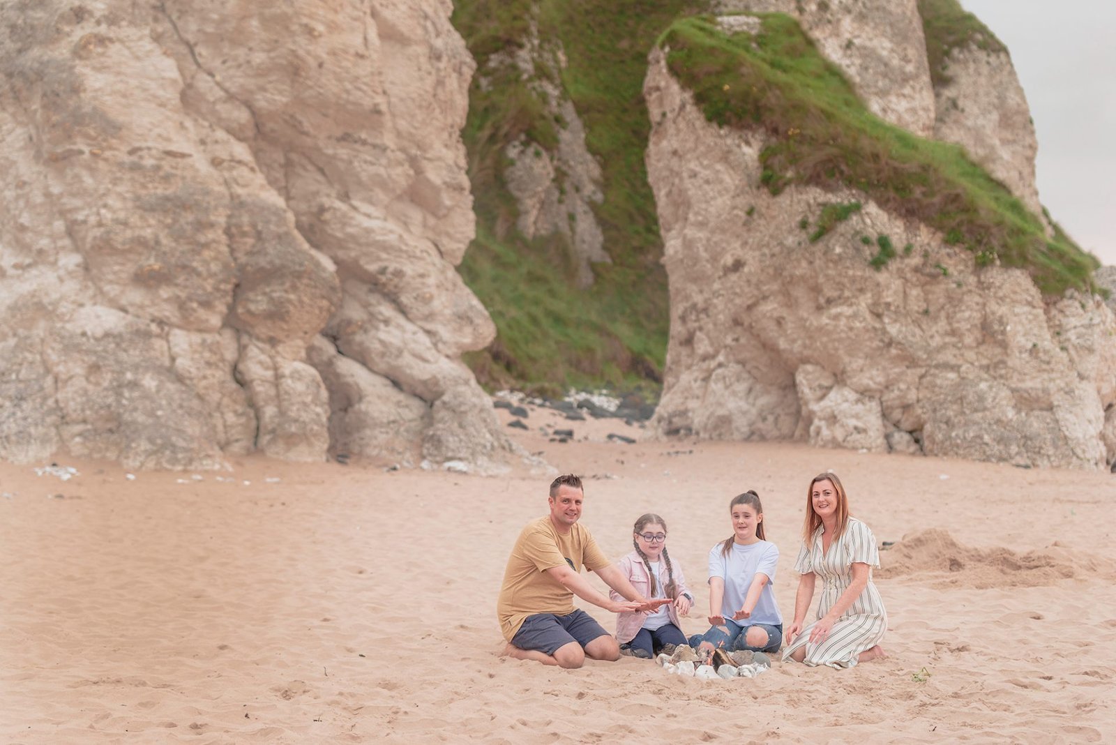The Art of Beach Portrait Photography: Essential Tips for Stunning Beach Portraits 2 A family poses on the beach in Northern Ireland, captured by a skilled NI photographer.