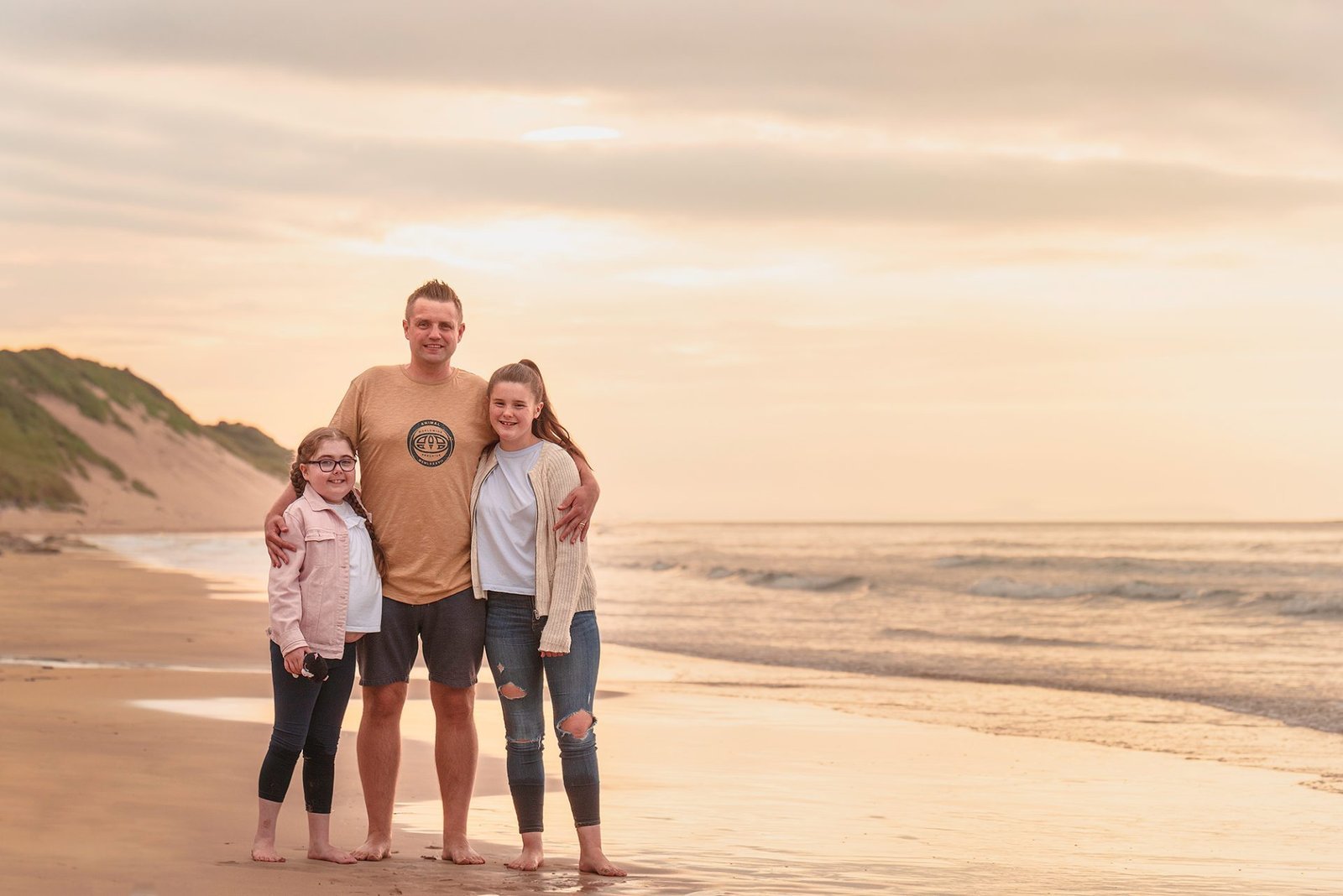 HOW NOT TO HAVE A NERVOUS BREAKDOWN AT YOUR FAMILY PORTRAIT SESSION! 2 A family photographed on the beach at sunset by a Northern Ireland family photographer.