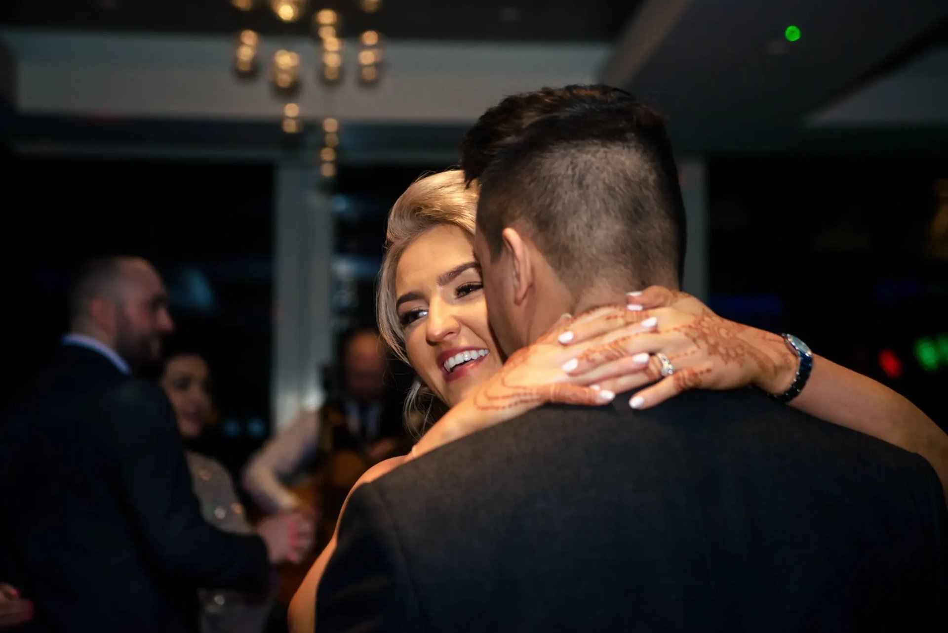 Small Wedding Ideas 4 Family Photographer A bride and groom hugging during their first dance captured by a wedding photographer.
