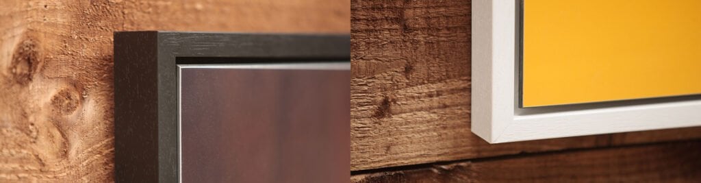 Seattle Tray Frame 1 Family Photographer A close-up view of two picture frames leaning against a wooden surface with a focus on the frame corners.