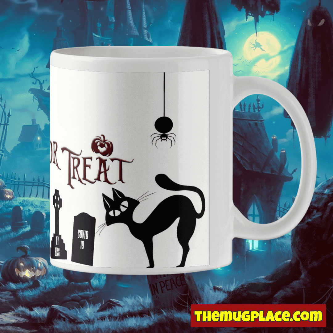 A white Halloween Mug with a black cat, spider, gravestones, and Trick or Treat text; spooky graveyard-themed background.