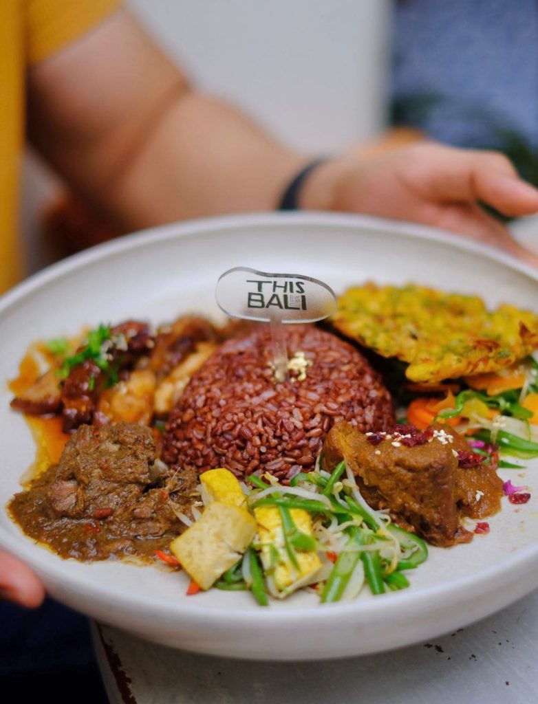 Authentic Indonesian Food you can find in Bali 2 Healthy Nasi Campur made with organic red rice served at THIS IS BALI restaurant in Ubud, offering nutritious Indonesian food at one of the best restaurants in Ubud