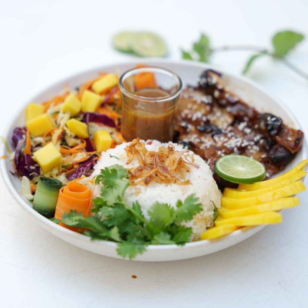 A Food Lover’s Guide to Authentic Balinese Dishes in Ubud 2 Combination of Honey Chicken and traditional Nasi Campur served at THIS IS BALI restaurant in Ubud, showcasing authentic Indonesian flavors from one of the best restaurants in Ubud