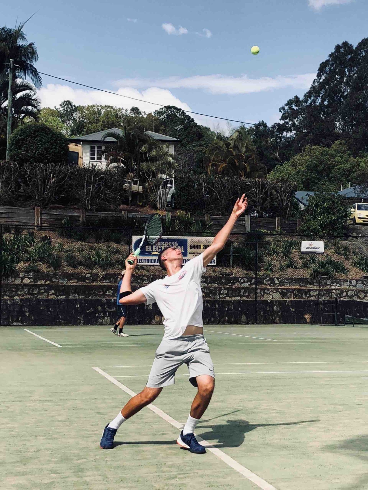 Photo of Dr Dean playing Tennis Photo of Dr Dean playing Tennis
