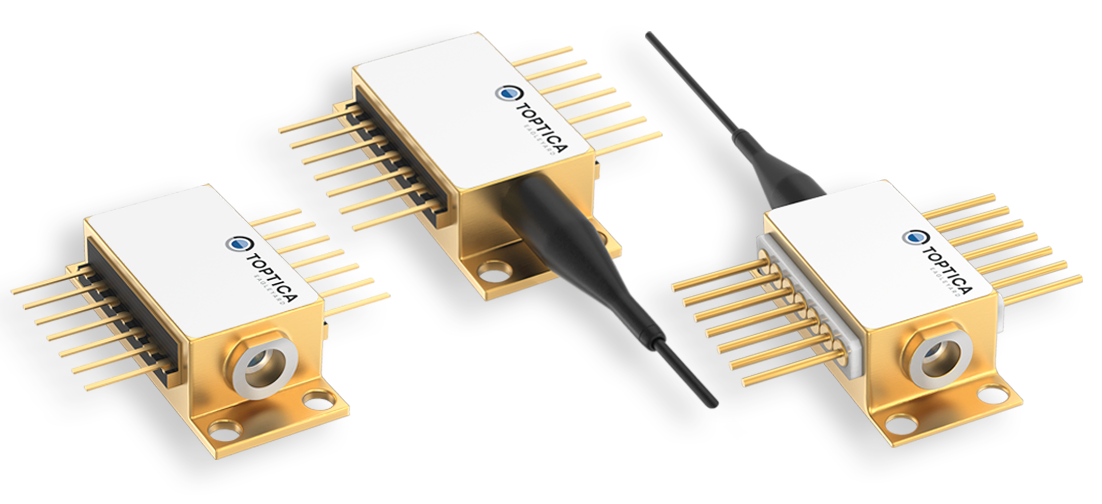 Three gold-hued TOPTICA laser modules with pins, one featuring a black fiber optic cable.